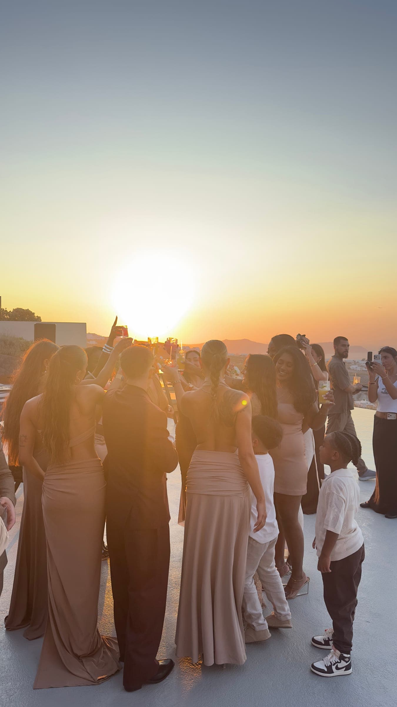 Guests celebrating at sunset